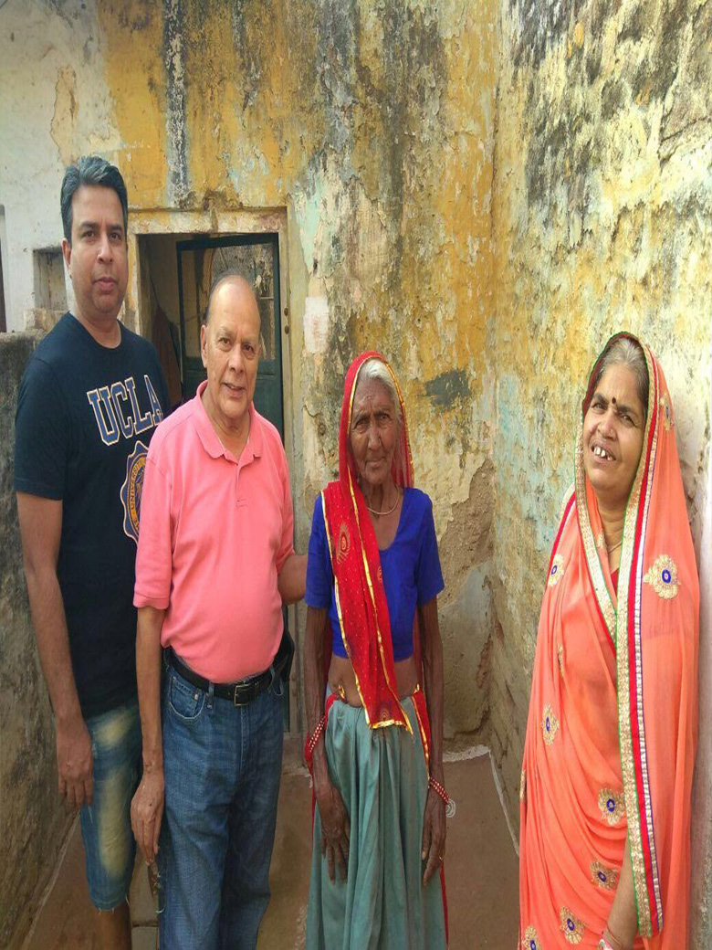 Dr. Shandilya providing Financial Aid to Impoverished Widows